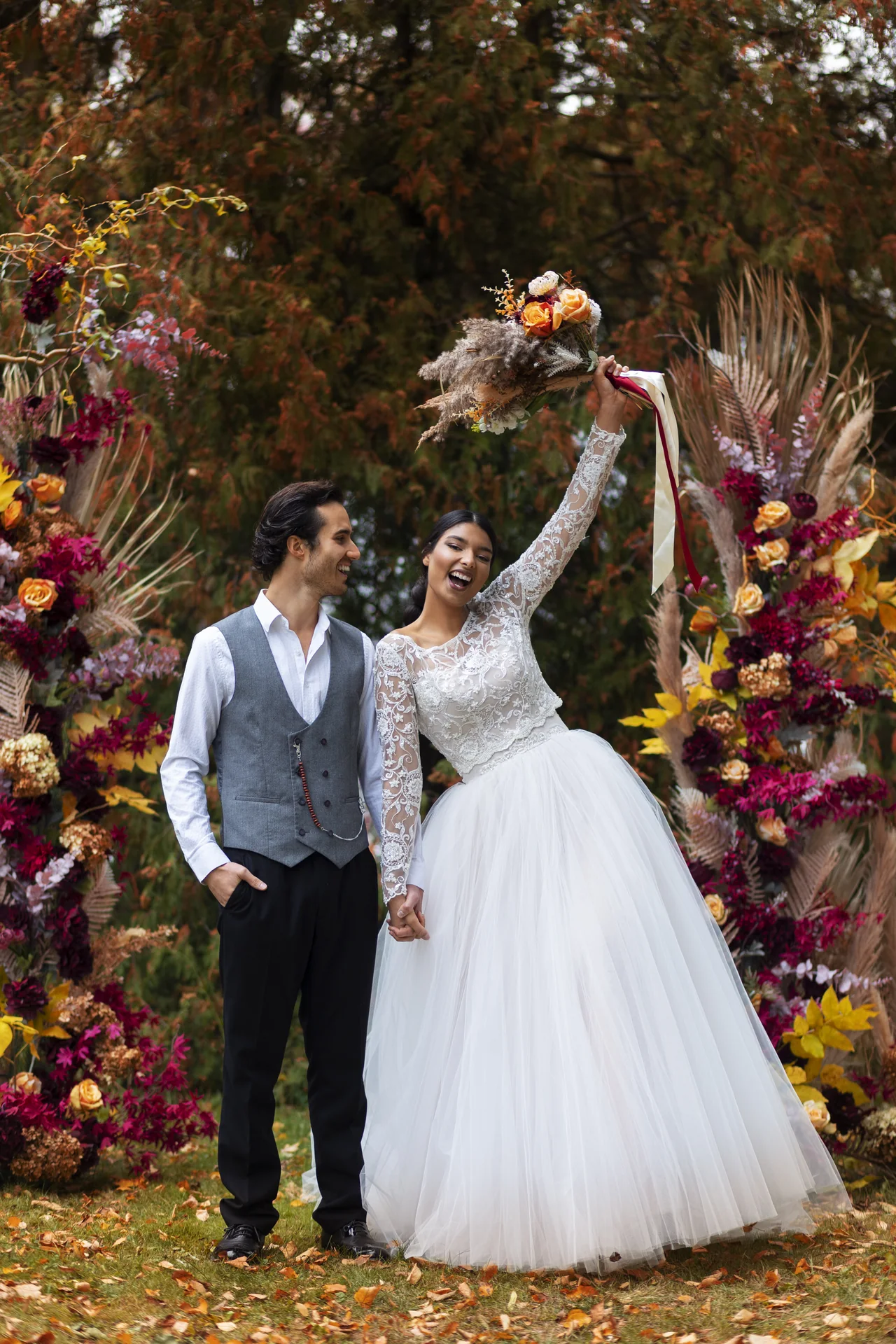 Happy wedding couple celebrating with flowers