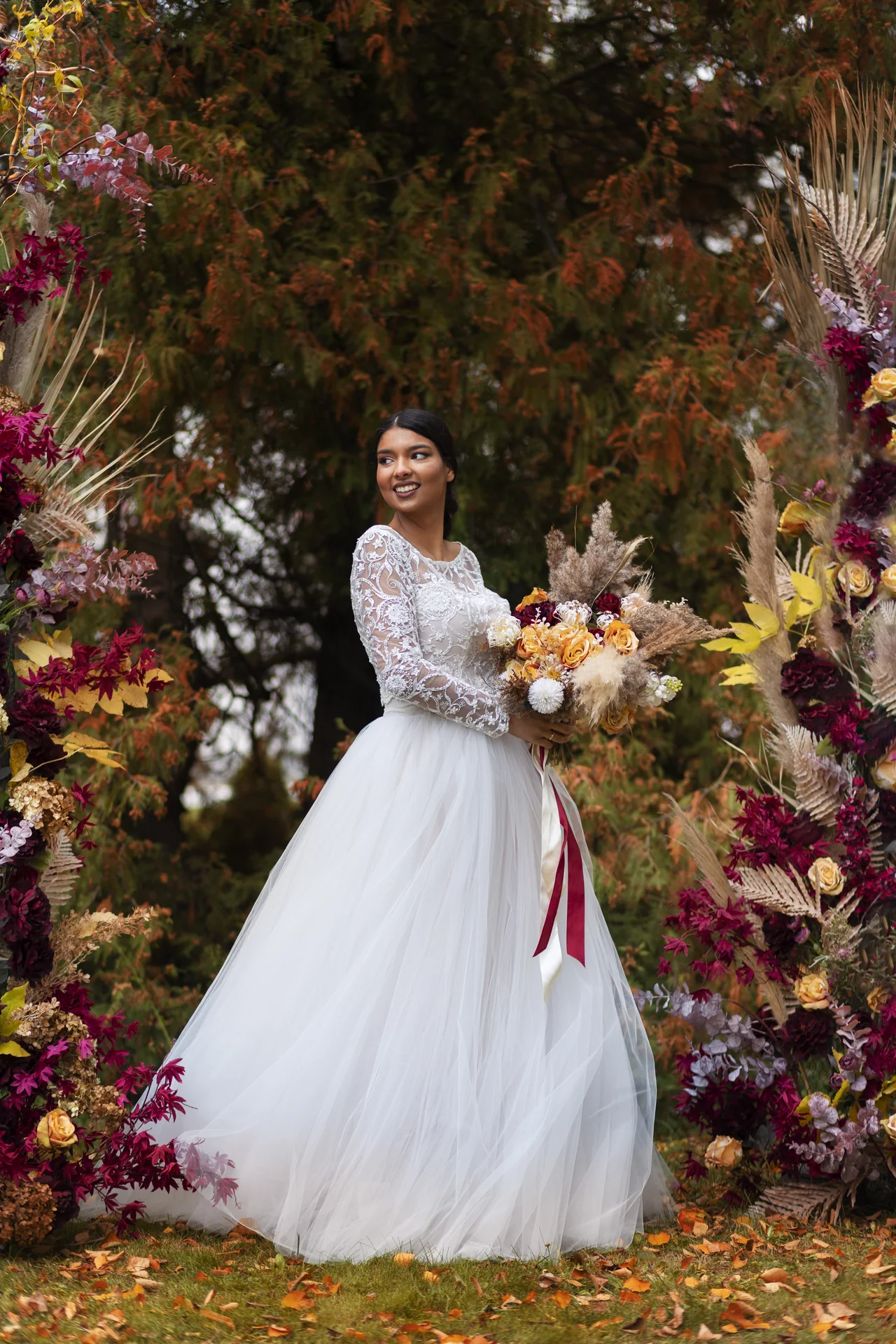 Smiling bride holding a floral bouquet